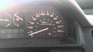 Close-up of a car dashboard showing a speedometer