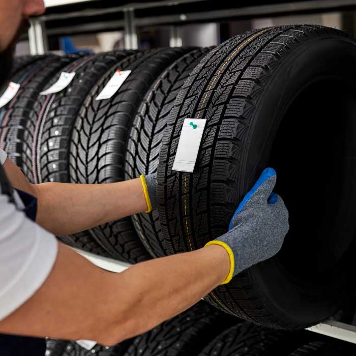 man pulling tire off shelf