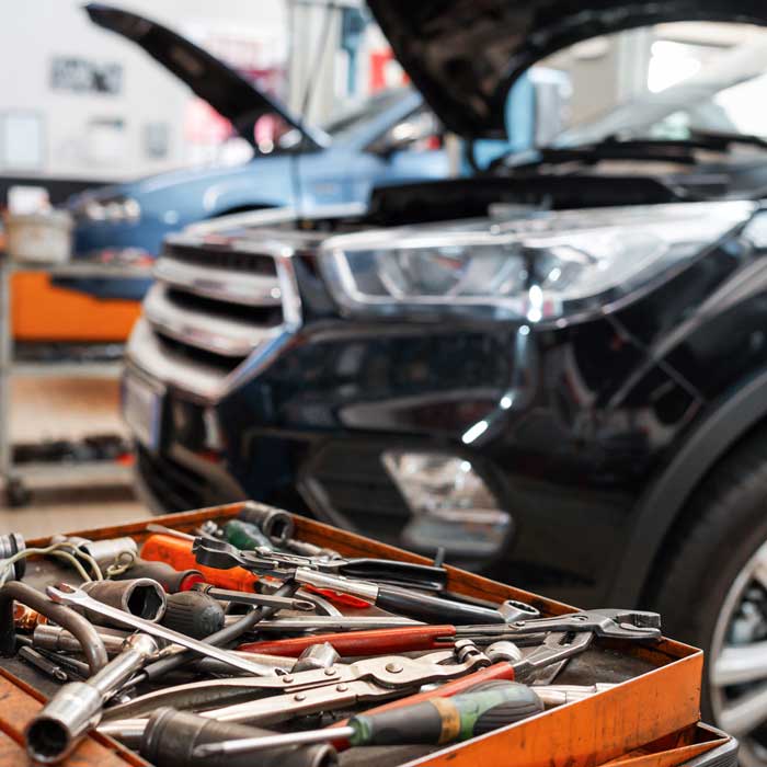 tools in foreground of auto body shop